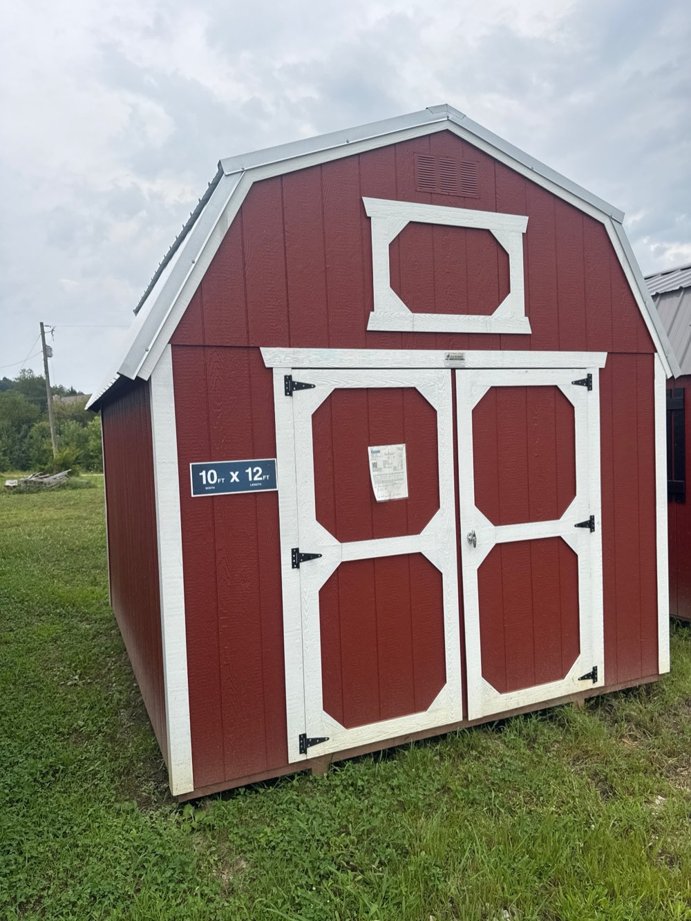 Lofted barn, 10 by 12, red siding with white trim and double doors