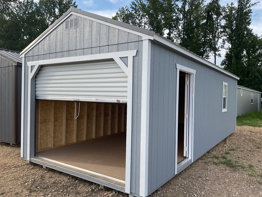 Utility shed, 12 by 28, gray siding with a roll-up door and a walk-in door